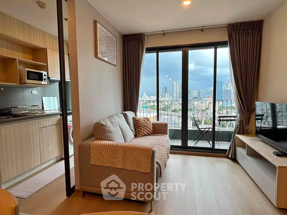 Modern living room with city view and open kitchen layout in high-rise apartment