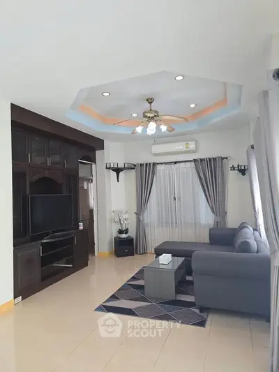 Spacious living room with modern decor and ceiling fan