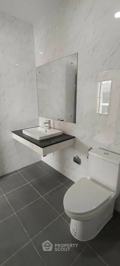 Modern bathroom with sleek fixtures and marble tiles