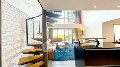 Modern loft-style living room with spiral staircase and large windows