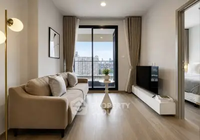Modern living room with city view, stylish decor, and cozy ambiance in a high-rise apartment.