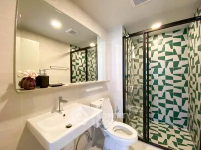 Modern bathroom with geometric tile shower and sleek fixtures