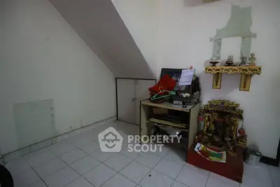 Cozy storage area with unique under-stair design and decorative elements.