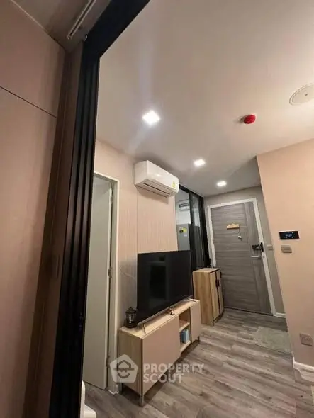 Modern living room with sleek design and air conditioning unit