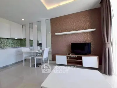 Modern living room with stylish decor and open kitchen layout, featuring sleek furniture and large windows.