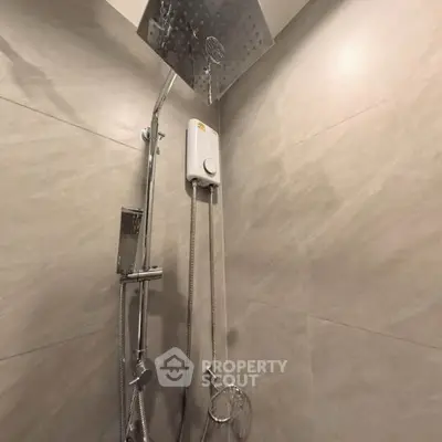 Modern bathroom with sleek shower fixtures and neutral tiles