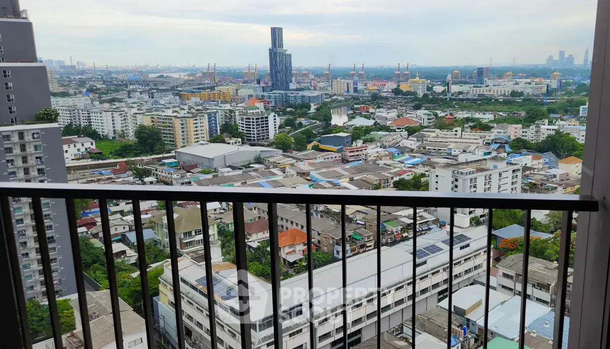 Stunning cityscape view from a high-rise balcony overlooking urban skyline and distant skyscrapers.
