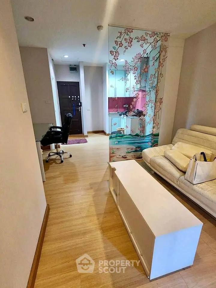 Modern living room with stylish decor and open layout, featuring a comfortable sofa and elegant wall art.