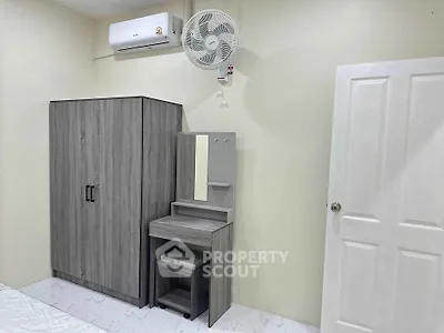 Modern bedroom with sleek wardrobe and vanity set, featuring air conditioning for comfort.