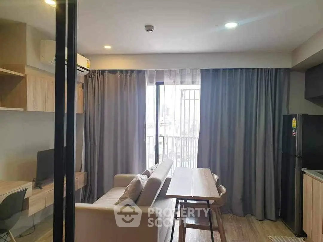 Modern living room with sleek furniture and balcony view in a stylish apartment.