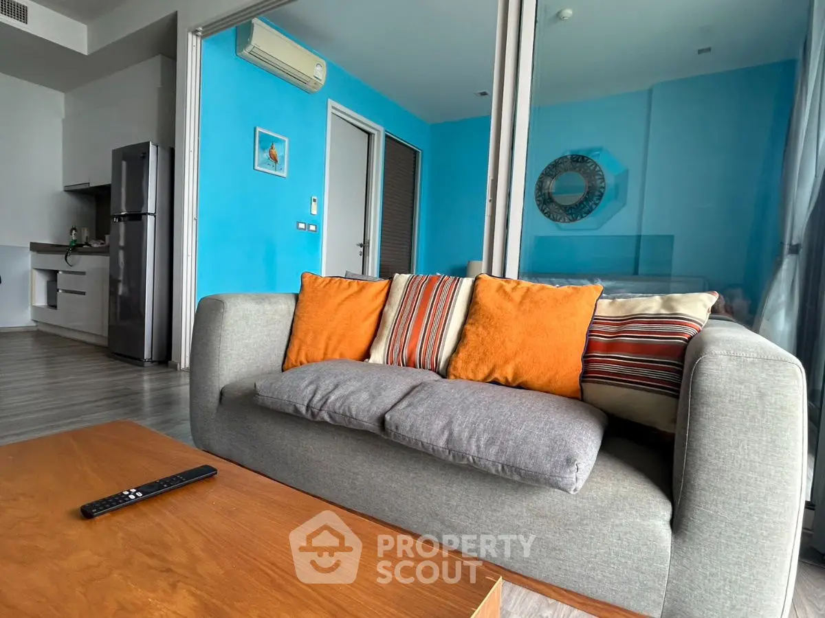 Modern living room with vibrant decor and sleek kitchen area