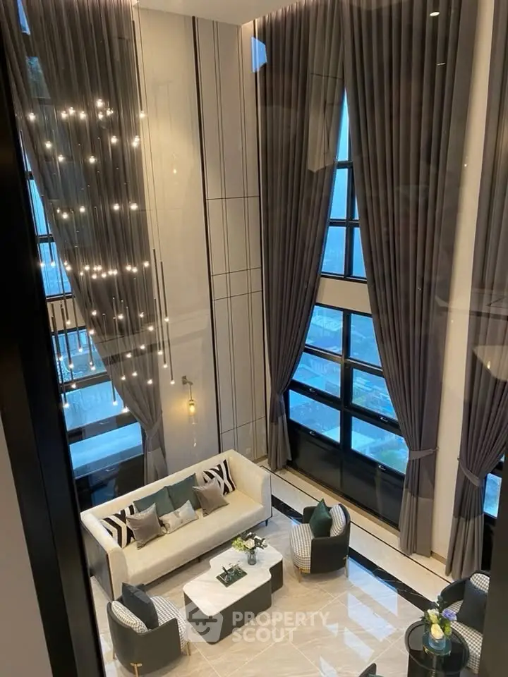 Luxurious high-ceiling living room with elegant decor and large windows offering stunning views.