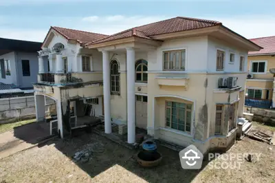 Spacious two-story house with classic architecture and large windows, ideal for renovation.