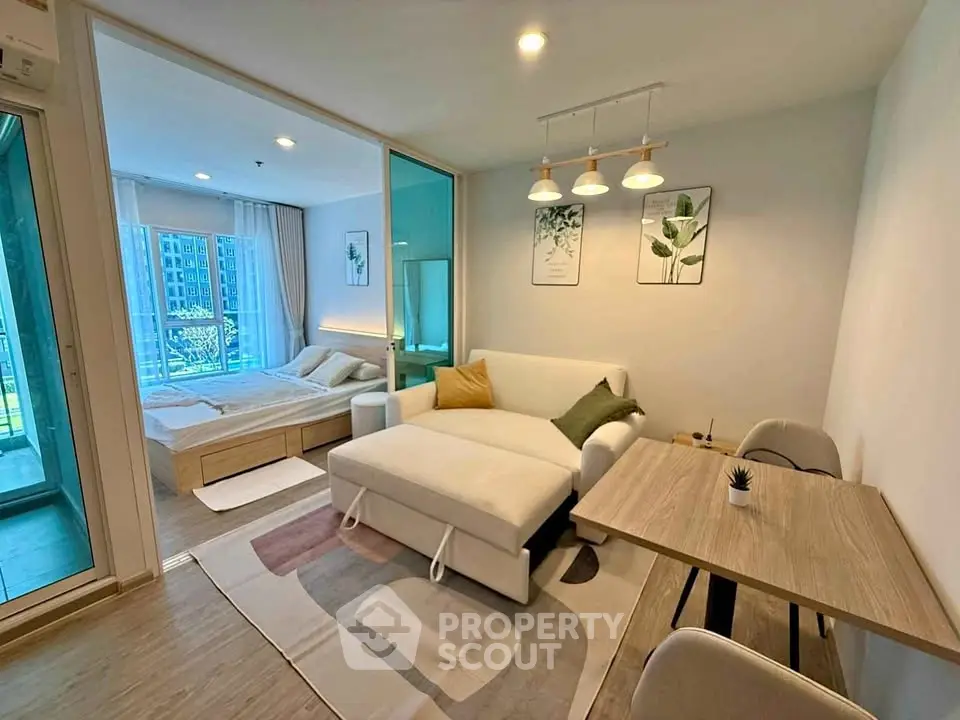 Modern studio apartment with stylish decor and open layout, featuring a cozy living area and bedroom with natural light.