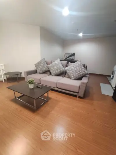 Spacious living room with modern sofa and wooden flooring