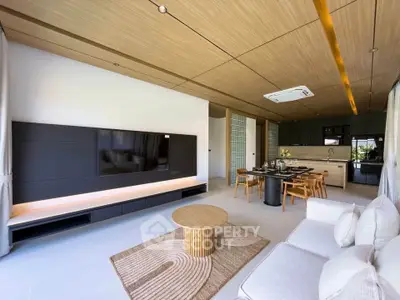 Modern open-plan living room with sleek kitchen, wooden ceiling, and stylish furniture.