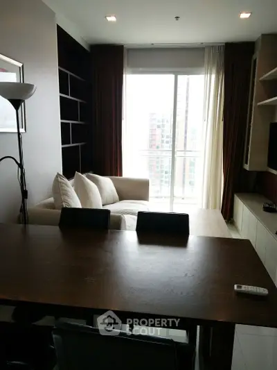Modern living room with large window and cozy seating area