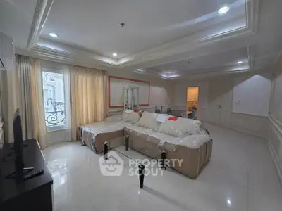 Spacious living room with elegant decor and large windows for natural light.