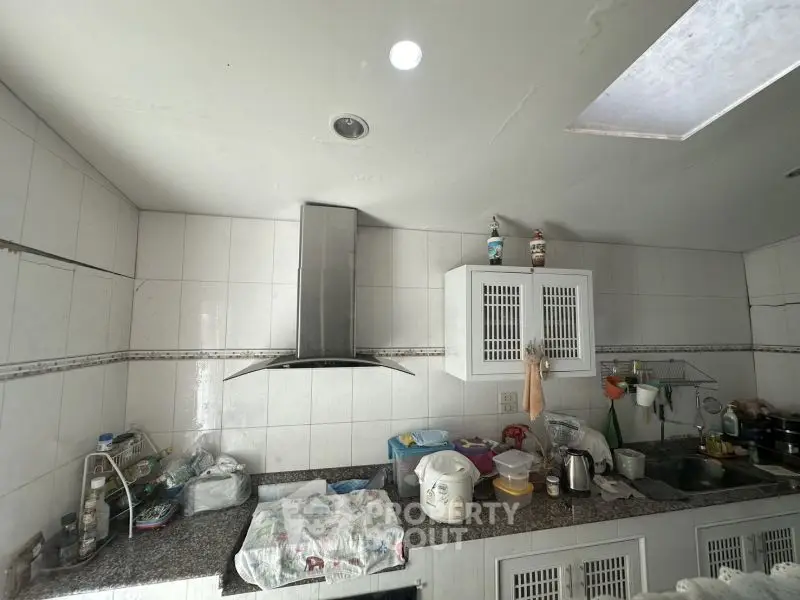 Spacious kitchen with modern hood and ample countertop space