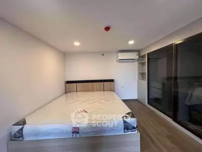 Modern bedroom with sleek design, featuring a large bed and built-in wardrobe, perfect for comfortable living.