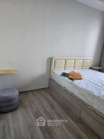 Modern bedroom with stylish flooring and cozy bed setup