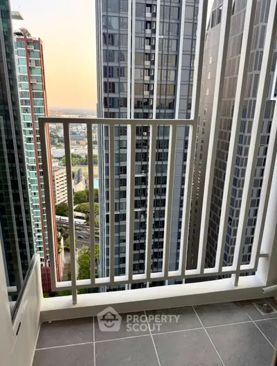 Modern high-rise balcony with stunning cityscape view, perfect for urban living enthusiasts.
