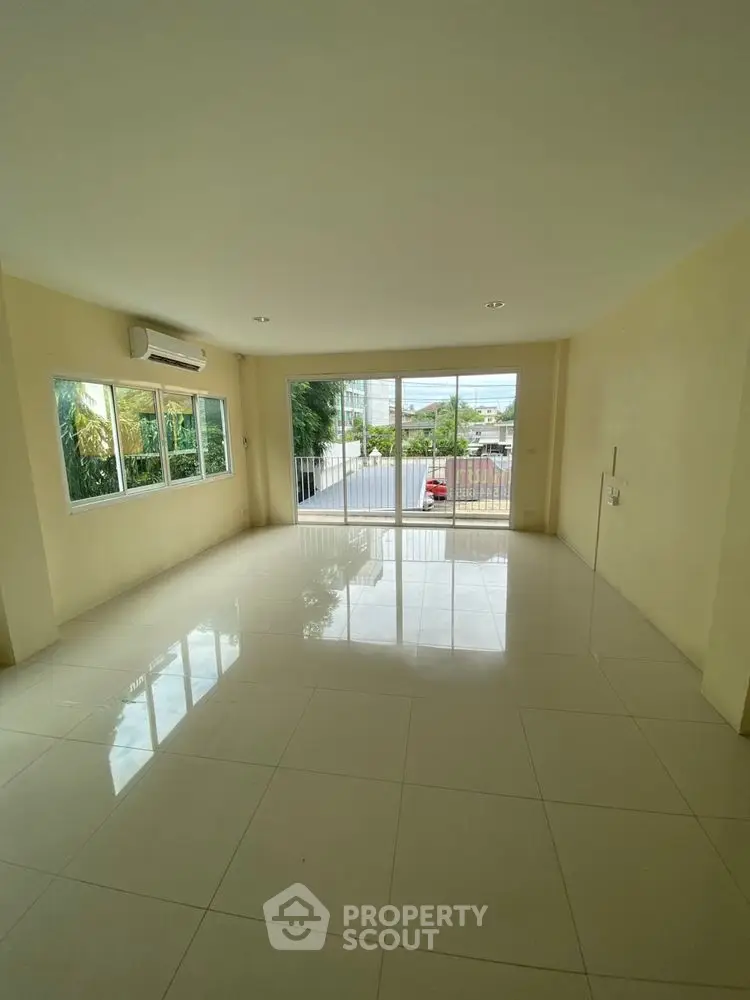 Spacious unfurnished living room with large windows and natural light