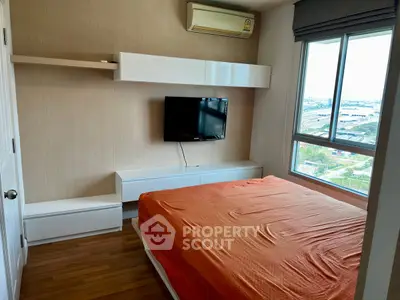 Modern bedroom with city view, wall-mounted TV, and air conditioning