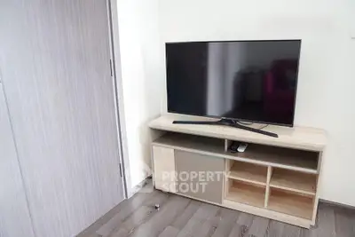 Modern living room with sleek TV stand and flat-screen television