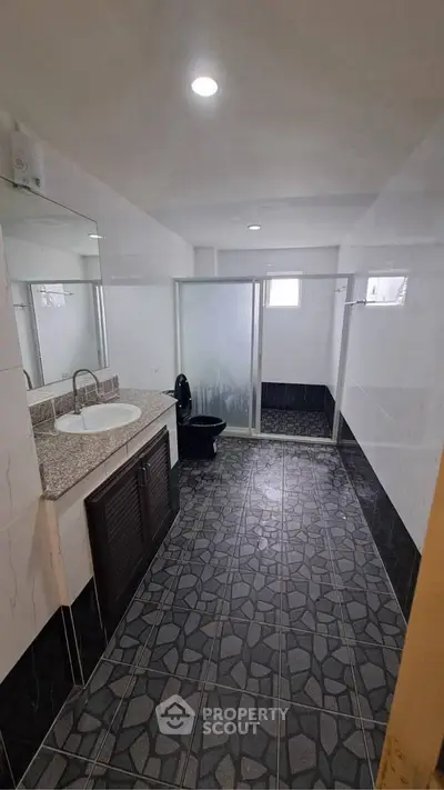 Spacious bathroom with modern fixtures and large shower area
