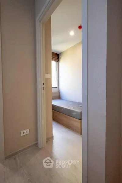 Cozy bedroom with natural light and minimalist design in modern apartment.