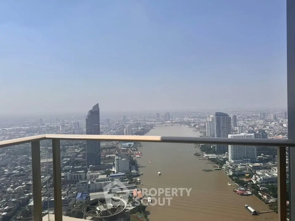 Stunning high-rise balcony view overlooking a river and city skyline, perfect for urban living.