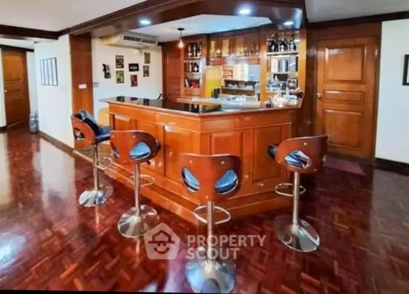 Luxurious home bar with wooden finish and modern bar stools