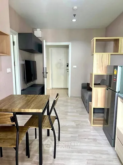 Modern apartment interior with open layout, featuring stylish dining area and cozy living space.