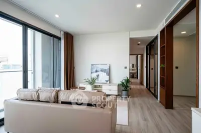 Modern living room with sleek design and natural light, featuring a cozy sofa and stylish decor.