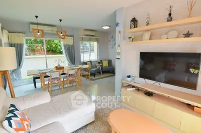 Spacious living room with modern decor and large windows offering natural light.