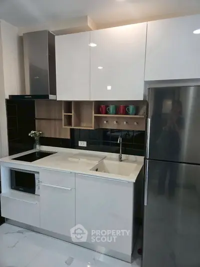 Modern kitchen with sleek cabinets, built-in appliances, and stylish backsplash.