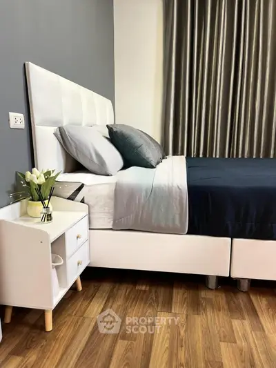 Elegant bedroom with modern decor and cozy bedding in a stylish apartment.