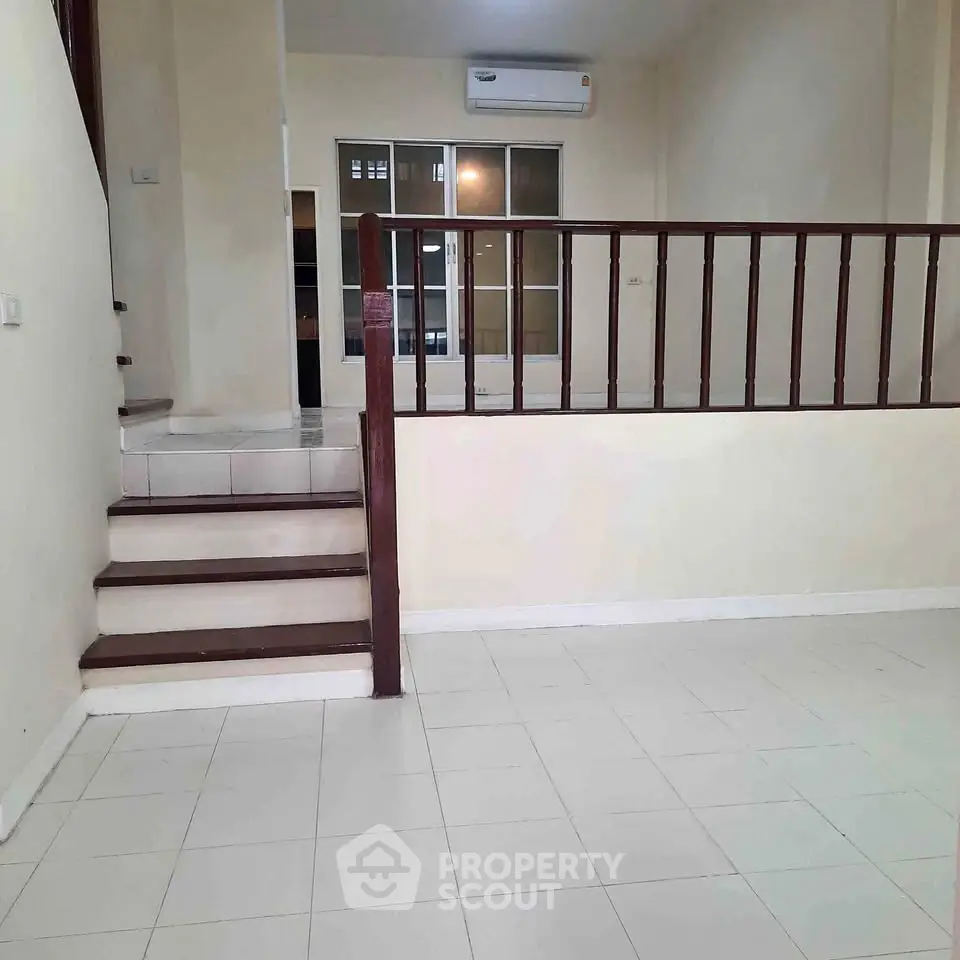 Spacious interior with split-level design and modern air conditioning unit.