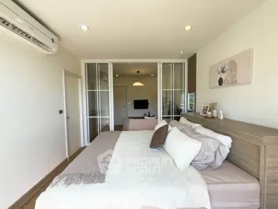 Modern bedroom with stylish decor and glass partition in a cozy apartment