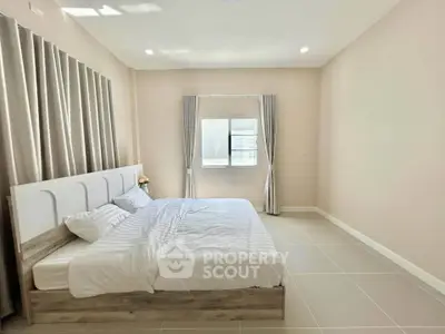 Spacious bedroom with modern decor and natural light