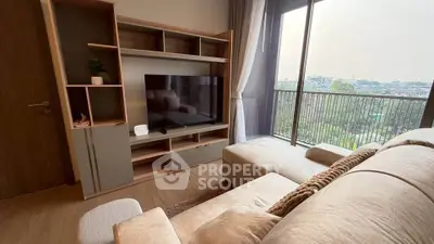 Cozy living room with plush sofa and city view balcony in modern apartment