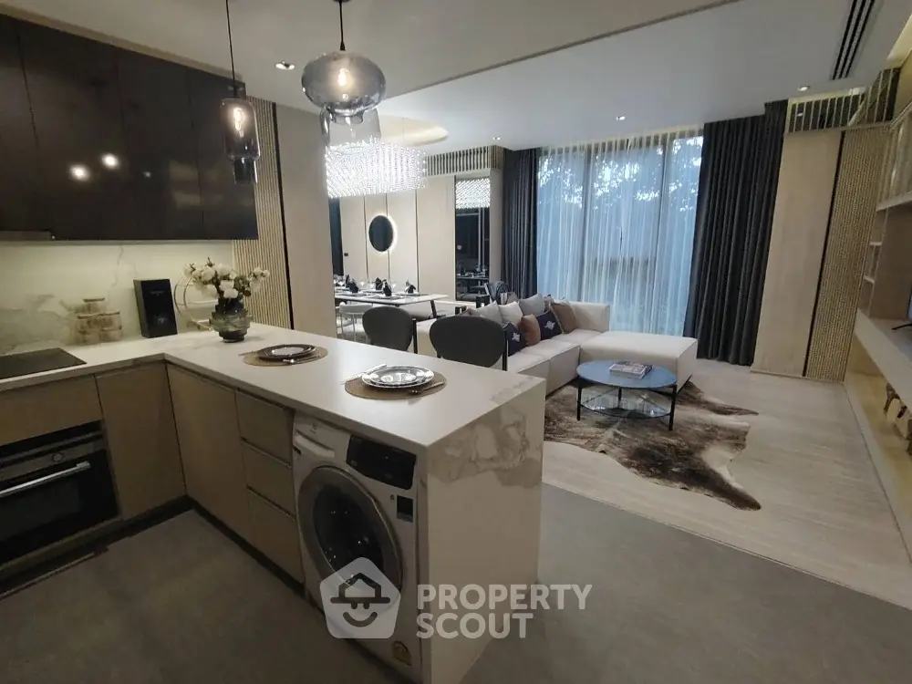 Luxurious open-plan living room with modern kitchen and stylish decor