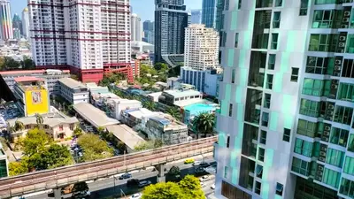 Stunning cityscape view from high-rise apartment with vibrant urban surroundings.