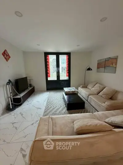 Spacious living room with modern decor and natural light