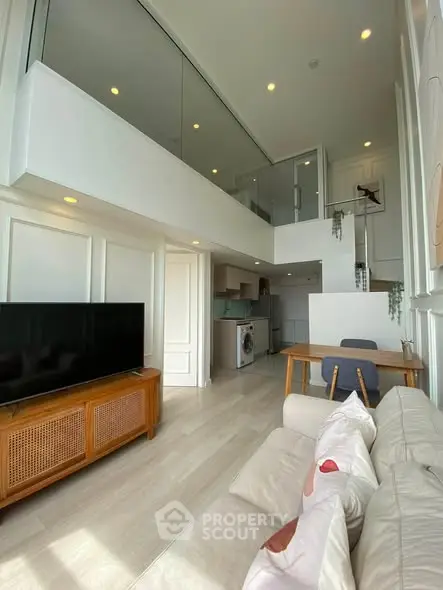 Modern loft apartment with high ceilings, open layout, and stylish furnishings.