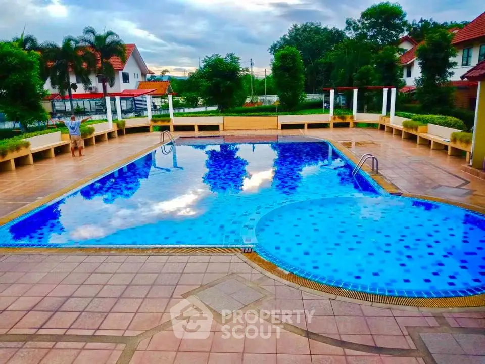 Stunning residential pool area with lush greenery and modern design.