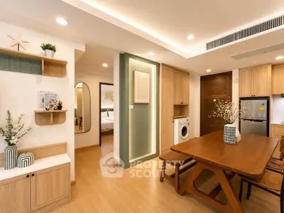 Modern open-plan living space with wooden furniture and built-in appliances, featuring a cozy dining area.