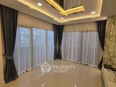 Luxurious living room with elegant curtains and modern ceiling design