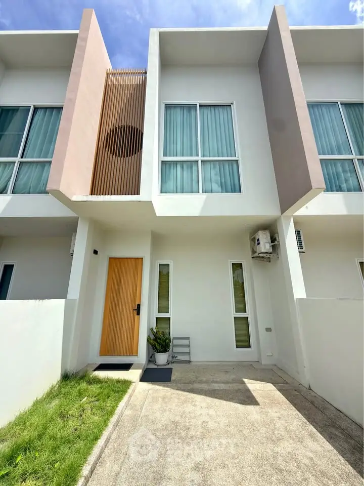 Modern townhouse exterior with sleek design and large windows, perfect for contemporary living.